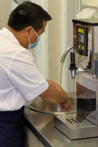 Kitchen staff washing hands